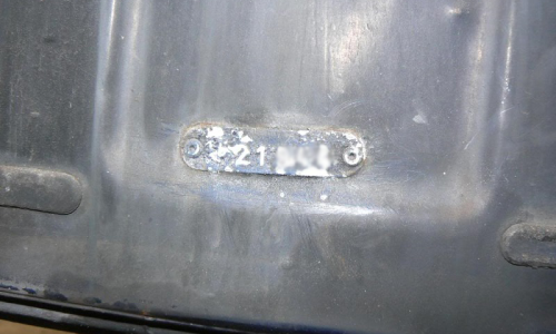 E-Type Jaguar Rear licence plate body number tag location.png