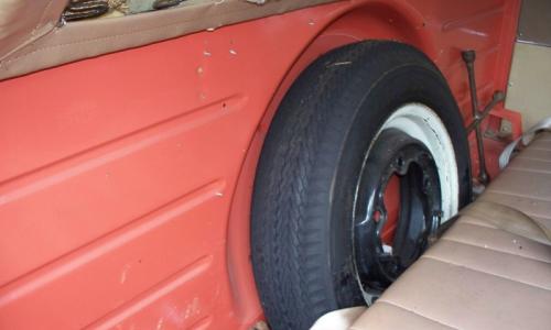 Spare wheel behind front seat in Volkswagen Deluxe Microbus.jpg